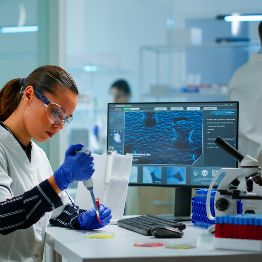 scientist modern equipped medical laboratory examinining drug discovery with micropipette medical stuff examining vaccine evolution using high tech technology researching treatment developmen scaled - Global ISO Certification Consultant Services - Qualitcert scientist modern equipped medical laboratory examinining drug discovery with micropipette medical stuff examining vaccine evolution using high tech technology researching treatment developmen scaled