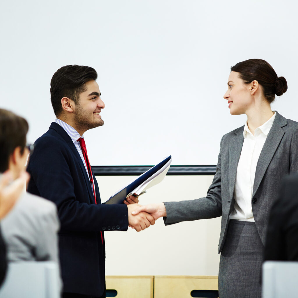 shaking hand speaker scaled - Global ISO Certification Consultant Services - Qualitcert shaking hand speaker scaled